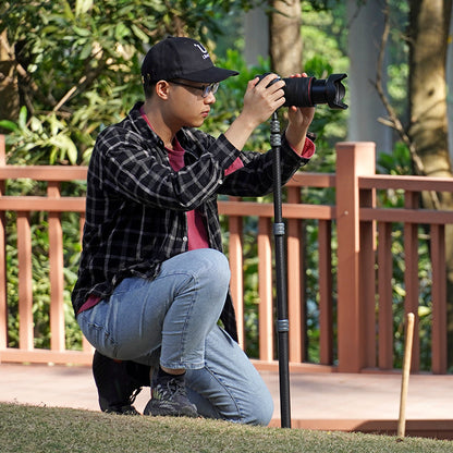 Ulanzi MT-49 Carbon Fiber Portable Camera Tripod in use, a person using tripod outdoor.