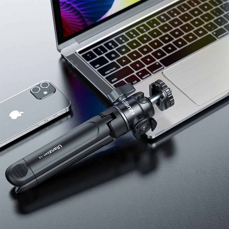 Ulanzi U-Vlog Lite extendable tripod grip with ball head beside laptop and smartphone